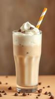 Creamy chocolate milkshake topped with whipped cream and chocolate chips in a tall glass photo