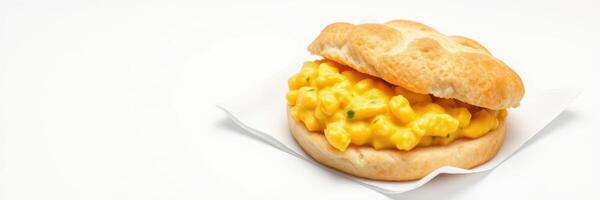 Biscuit sandwich with cheesy scrambled eggs served on a napkin in a bright setting photo