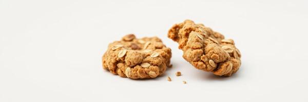 Delicious oatmeal cookies on a simple white background with one cookie broken in half photo
