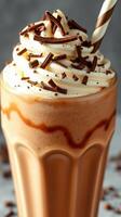 Delicious chocolate milkshake topped with whipped cream and chocolate shavings in a tall glass photo
