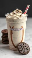 Creamy milkshake with cookie toppings and a striped straw on a marble surface photo