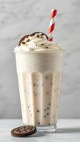Creamy dessert beverage topped with whipped cream and a cookie at a cafe photo