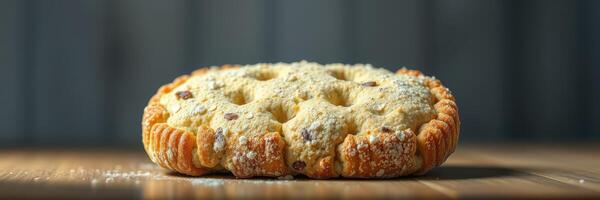 Freshly baked dessert on wooden surface with powdered sugar dusting in cozy kitchen setting photo