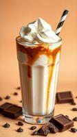 Creamy chocolate milkshake topped with whipped cream and chocolate drizzle served in a tall glass photo