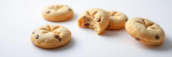 Delicious chocolate chip cookies on a clean surface with a bite taken from one photo