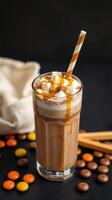 Chocolate drink with caramel sauce and marshmallows served with candy on a dark background in a cozy setting photo