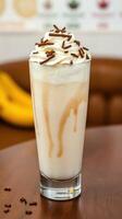 Creamy dessert drink topped with whipped cream and chocolate sprinkles in a cozy setting photo