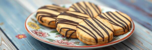 Delicious homemade cookies arranged on a floral plate with chocolate drizzle photo
