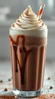 Indulgent chocolate milkshake topped with whipped cream and chocolate drizzle in a glass photo