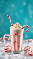 Creamy peppermint milkshake topped with whipped cream and candy canes photo