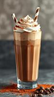 Luxurious chocolate milkshake topped with whipped cream and striped straws served in a tall glass photo