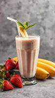 Smoothie preparation featuring fresh strawberries and bananas on a textured surface photo