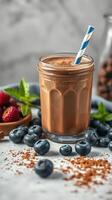Delicious chocolate smoothie served with fresh berries on a marble countertop photo