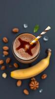 Delicious chocolate banana smoothie with almonds served in a glass on a dark background photo