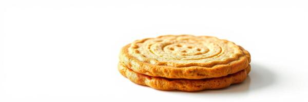Delicious golden cookies stacked on a white background ready for a sweet treat experience photo