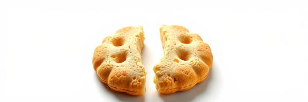 Freshly baked biscuit split in half on a clean white surface showcasing its texture and fluffiness photo