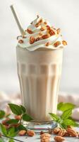 Delicious creamy beverage topped with whipped cream and nuts served in a glass photo