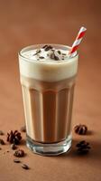 Creamy iced coffee topped with whipped cream and chocolate sprinkles served with a straw photo
