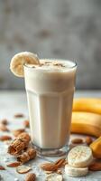 Creamy banana smoothie with almonds captures refreshing taste in a cozy kitchen setting photo