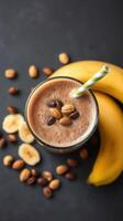Smoothie with bananas and coffee beans served on a dark surface during afternoon snack time photo