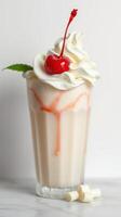 Indulgent milkshake topped with whipped cream, cherry, and a splash of syrup for a sweet treat experience photo