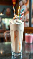Delicious milkshake topped with whipped cream and colorful sprinkles in a cozy cafe setting photo