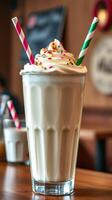 Creamy vanilla milkshake topped with whipped cream and colorful sprinkles served in a diner photo