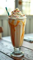 Delicious milkshake topped with whipped cream and colorful sprinkles served in a tall glass photo