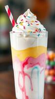 Colorful layered dessert with whipped cream and sprinkles in a glass, enjoyed on a warm day photo