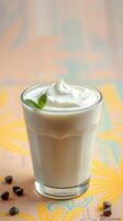 Refreshing creamy drink topped with whipped cream and mint on a vibrant background photo