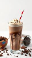 Delicious chocolate milkshake topped with whipped cream and chocolate shavings served in a tall glass photo