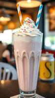 Delicious milkshake topped with whipped cream and sprinkles enjoyed in a vibrant diner setting photo