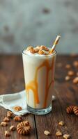 Creamy dessert drink with caramel drizzle and crunchy toppings on a wooden table photo