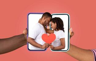 A couple shares a loving moment while engaging with their smartphones. They hold devices that display each other, symbolizing modern communication and connection in their relationship. photo