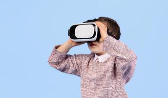 A happy girl engages with virtual reality technology, exploring a captivating digital world. photo