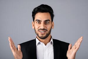 A Middle Eastern businessman showcases enthusiasm with a broad smile and outstretched arms. Dressed in a formal suit, he stands in a studio environment, portraying a vibrant corporate lifestyle. photo