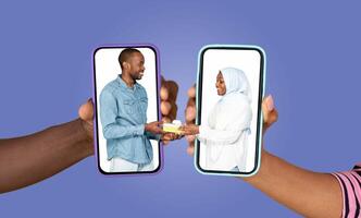 In a lively setting, a couple joyfully exchanges messages on their smartphones. Each holds a phone showcasing the other, celebrating their connection through digital communication. photo