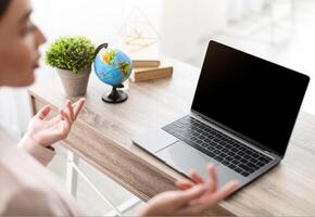 Online Communication. Unrecognizable Businesswoman Talking To Laptop Empty Screen Having Call Consulting Client Remotely Sitting At Desk In Modern Office. Selective Focus, Mockup photo