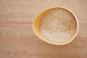 A CloseUp Image Showing White Rice Grains Neatly Arranged in a Pile photo