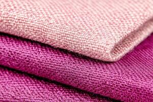 Close-up view of textured velvet fabric in dusty rose and deep purple tones showcasing luxury and coziness photo