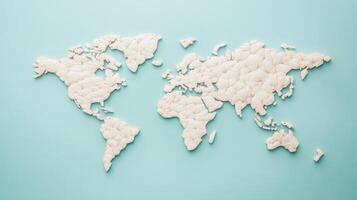 A tactile world map crafted from cotton sits against a calming blue backdrop, symbolizing global connections photo