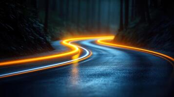 A winding road cuts through a dark forest, illuminated by vibrant glowing lines under a misty night sky photo
