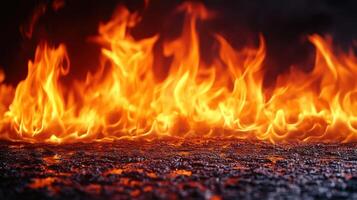Vivid flames rise, casting an orange glow in the darkness, creating a striking fire display photo