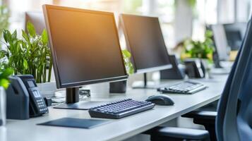 A modern office setup showcases computer monitors and keyboards beside vibrant green plants in a bright workspace photo