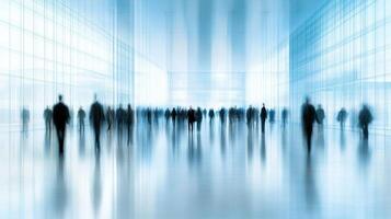 A large crowd moves through a bright, spacious area featuring extensive glass architecture and a lively ambiance photo