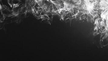 Swirling patterns of smoke gracefully ascend into the air, creating an ethereal effect against a dark backdrop photo