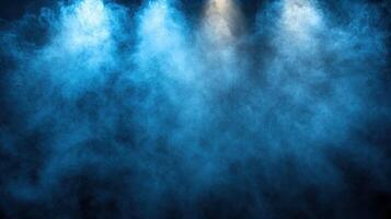 A blue fog fills the air under focused lights, setting a mysterious and moody atmosphere for any event or performance photo