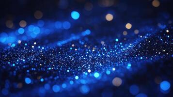 Glitter sparkles in shades of blue and gold across a dark surface, evoking a magical, starry night effect photo