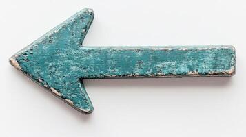 A weathered teal arrow sign directs viewers to the left against a light background, suggesting navigation photo