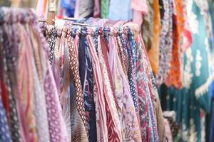 A Vibrant Array of Colorful Scarves Displayed at a Local Market Stall photo